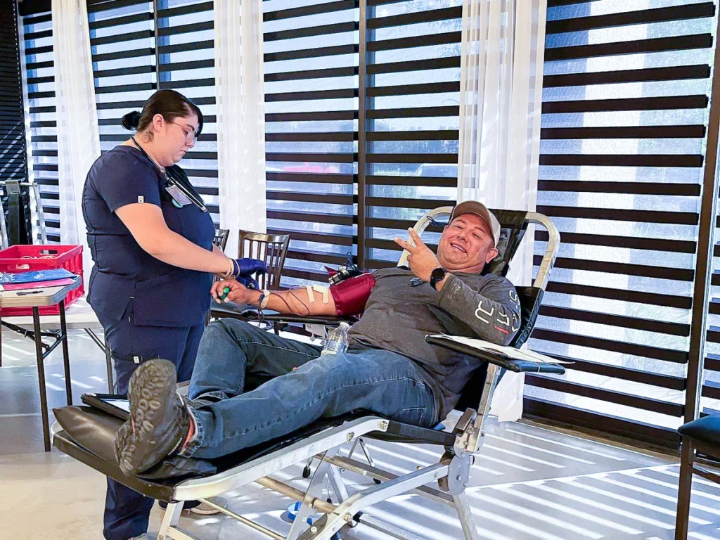 A man checking his blood pressure at Houston fundraiser venue - Up Above Venue