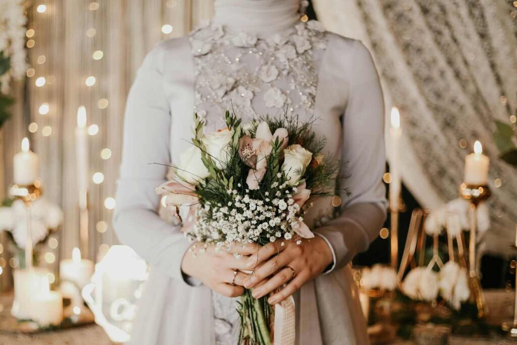 A bride standing by holding flowers with well organized Ttheme and style in a venue